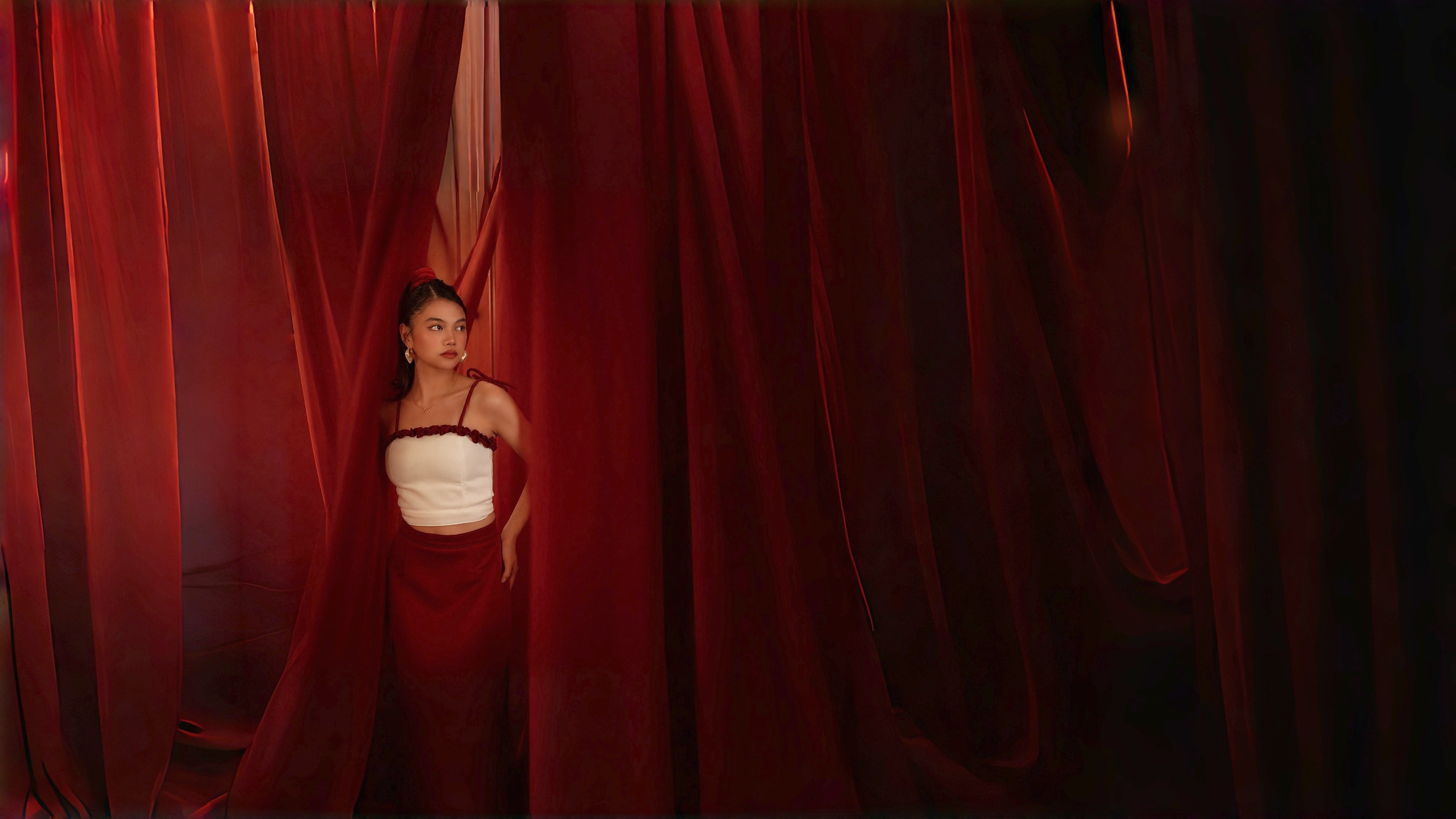 A piece from the house worn between velvet curtains